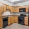 a kitchen with wooden cabinets and black appliances