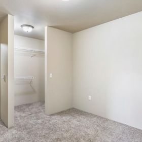 Generous bedroom offerings to fit every family a room with white walls and carpet